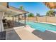 Inviting backyard oasis with a sparkling pool, covered patio, and lounging area at 4944 W Vista Ave, Glendale, AZ 85301