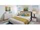 Bright bedroom with stylish furnishings, plush bedding, and decorative wall art at 5012 S 106Th Ln, Tolleson, AZ 85353