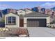 Charming single-story home with a desert landscape, mountain views, and a two-car garage at 5012 S 106Th Ln, Tolleson, AZ 85353