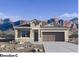 Modern single-Gathering home with desert landscaping and an attached two-car garage at 5020 S 106Th Ln, Tolleson, AZ 85353