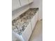 A detailed view of the kitchen's elegant granite countertop and sleek cabinetry at 5020 S 106Th Ln, Tolleson, AZ 85353