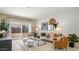 Cozy living room featuring stylish decor and sliding glass doors to the backyard at 5020 S 106Th Ln, Tolleson, AZ 85353