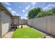 Well-maintained backyard with artificial turf, a shaded patio, and a privacy wall at 609 E Royal Palm S Sq, Phoenix, AZ 85020