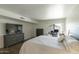 Inviting bedroom featuring a plush bed, dresser, and a sunny workspace by the sliding glass door at 609 E Royal Palm S Sq, Phoenix, AZ 85020