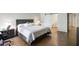 Bedroom showcasing a cozy bed, a sliding barn door bathroom entrance, and a workspace area at 609 E Royal Palm S Sq, Phoenix, AZ 85020