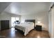 Spacious bedroom with a comfortable bed, dresser, and a desk set up near a sliding glass door at 609 E Royal Palm S Sq, Phoenix, AZ 85020
