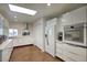 Modern white kitchen featuring stainless appliances and ample counter space at 609 E Royal Palm S Sq, Phoenix, AZ 85020