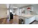 Open-concept kitchen featuring white cabinets, stainless appliances, and bar seating at 609 E Royal Palm S Sq, Phoenix, AZ 85020