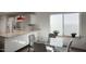 Bright kitchen and dining area featuring modern white cabinetry and a large window at 609 E Royal Palm S Sq, Phoenix, AZ 85020