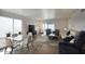 Bright and airy living room with sliding doors and a dining area near the window at 609 E Royal Palm S Sq, Phoenix, AZ 85020