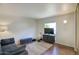 Comfortable living room with a sofa, mounted TV, and area rug, perfect for relaxation at 609 E Royal Palm S Sq, Phoenix, AZ 85020