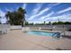 Community pool area featuring clear blue water, ample decking, and lounge seating at 609 E Royal Palm S Sq, Phoenix, AZ 85020