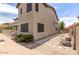 View of the home's side yard and backyard with patio and block fencing at 614 E Benrich Dr, Gilbert, AZ 85295