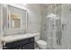 Bathroom featuring a vanity with a stone countertop, toilet, and glass shower with decorative tiling at 614 E Benrich Dr, Gilbert, AZ 85295