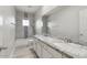 Bathroom with tiled walls, vanity with stone countertop, large mirror, and a shower/tub combo at 614 E Benrich Dr, Gilbert, AZ 85295