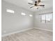 Bright, empty bedroom with hardwood floors, a ceiling fan, and ample natural light from the windows at 614 E Benrich Dr, Gilbert, AZ 85295