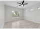 Bedroom with a ceiling fan, hardwood flooring, and a large window, providing a cozy retreat at 614 E Benrich Dr, Gilbert, AZ 85295