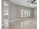 Bright bedroom with plantation shutters, neutral walls, and modern ceiling fan at 614 E Benrich Dr, Gilbert, AZ 85295