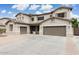 Expansive two-story home featuring a three-car garage and neutral stucco exterior with beautiful landscaping at 614 E Benrich Dr, Gilbert, AZ 85295