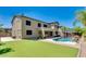 Back of the home with a large pool and lush backyard, ideal for entertaining at 614 E Benrich Dr, Gilbert, AZ 85295