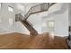 Bright foyer featuring hardwood floors, staircase with iron railing, large windows, and modern lighting at 614 E Benrich Dr, Gilbert, AZ 85295