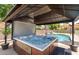 Relaxing hot tub with gazebo located next to the beautiful in-ground swimming pool at 614 E Benrich Dr, Gilbert, AZ 85295
