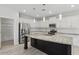 Well-lit kitchen features white cabinets, stainless appliances, and large center island with granite countertops at 614 E Benrich Dr, Gilbert, AZ 85295