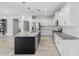 Kitchen with stainless steel appliances, granite countertops, white cabinets, and a large island at 614 E Benrich Dr, Gilbert, AZ 85295
