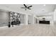 Bright living room with fireplace, tiled floors, ceiling fan, and open floor plan at 614 E Benrich Dr, Gilbert, AZ 85295