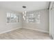 Bright and airy living room with wood tile flooring and plantation shutters for privacy at 614 E Benrich Dr, Gilbert, AZ 85295