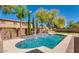 Inviting pool with water feature, surrounded by lush landscaping and mature trees at 614 E Benrich Dr, Gilbert, AZ 85295