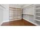 Spacious walk-in closet with custom shelving and wood floors at 614 E Benrich Dr, Gilbert, AZ 85295
