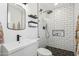Modern bathroom featuring black fixtures, sleek vanity, and a glass-enclosed shower with subway tile at 653 W Inglewood St, Mesa, AZ 85201