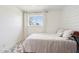 Neutral bedroom with a plush rug, natural light, and workspace, creating a comfortable ambiance at 653 W Inglewood St, Mesa, AZ 85201
