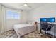 Cozy bedroom with a plush rug, shiplap wall, and comfortable workspace by the window at 653 W Inglewood St, Mesa, AZ 85201