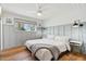 Cozy bedroom with wood paneled accent wall, hardwood floors, and ample natural light at 653 W Inglewood St, Mesa, AZ 85201