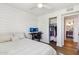 Bright bedroom with a computer desk, shiplap accent wall, and closet at 653 W Inglewood St, Mesa, AZ 85201