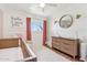Inviting Bedroom with a crib, dresser, and soft lighting, creating a serene atmosphere at 653 W Inglewood St, Mesa, AZ 85201
