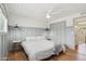 Comfortable bedroom featuring wood floors, stylish lighting, and ample closet space at 653 W Inglewood St, Mesa, AZ 85201
