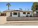 Charming single-story home featuring a neutral color scheme, well-manicured landscape and a welcoming front entrance at 653 W Inglewood St, Mesa, AZ 85201