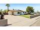Attractive single-story home featuring a lush green lawn, a covered carport, and a welcoming front yard at 653 W Inglewood St, Mesa, AZ 85201