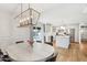 Open-concept kitchen and dining area with stainless steel appliances and pendant lighting at 653 W Inglewood St, Mesa, AZ 85201