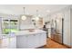 Modern kitchen featuring an island, stainless steel appliances, and sliding glass doors to the backyard at 653 W Inglewood St, Mesa, AZ 85201
