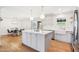 Modern kitchen with an island, stainless steel appliances, and a dining area in the background at 653 W Inglewood St, Mesa, AZ 85201