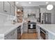 Modern kitchen featuring stainless steel appliances, shaker cabinets, and white subway tile backsplash at 653 W Inglewood St, Mesa, AZ 85201