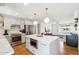 Modern kitchen with an island, stainless steel appliances, and an open view to the living room at 653 W Inglewood St, Mesa, AZ 85201