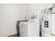 Functional laundry room equipped with a washer, dryer, and water heater for convenience at 653 W Inglewood St, Mesa, AZ 85201