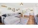 Open-concept living room featuring hardwood floors, a comfortable sectional couch, and seamless flow to the kitchen at 653 W Inglewood St, Mesa, AZ 85201