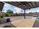 Spacious backyard with a mix of rock and paved surfaces, plants, and block perimeter fencing at 6810 E Almeria Rd, Scottsdale, AZ 85257