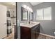 This bathroom is equipped with a double sink vanity and a shower with subway tile at 6810 E Almeria Rd, Scottsdale, AZ 85257